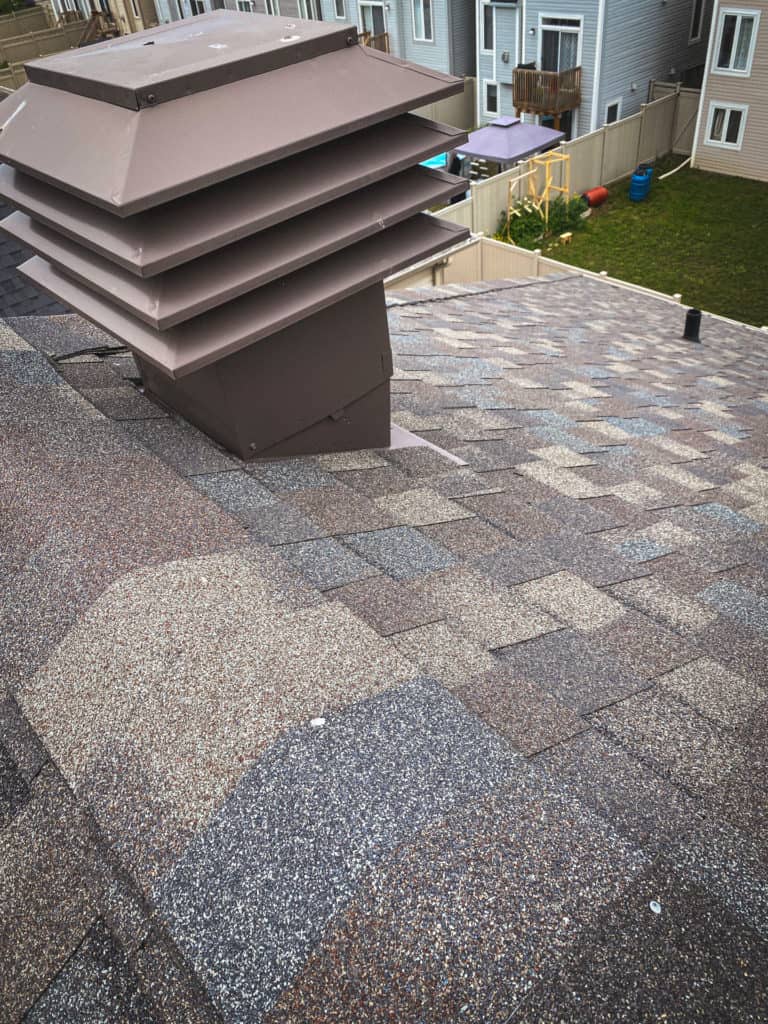 new roof with brown shingles and ventilation system